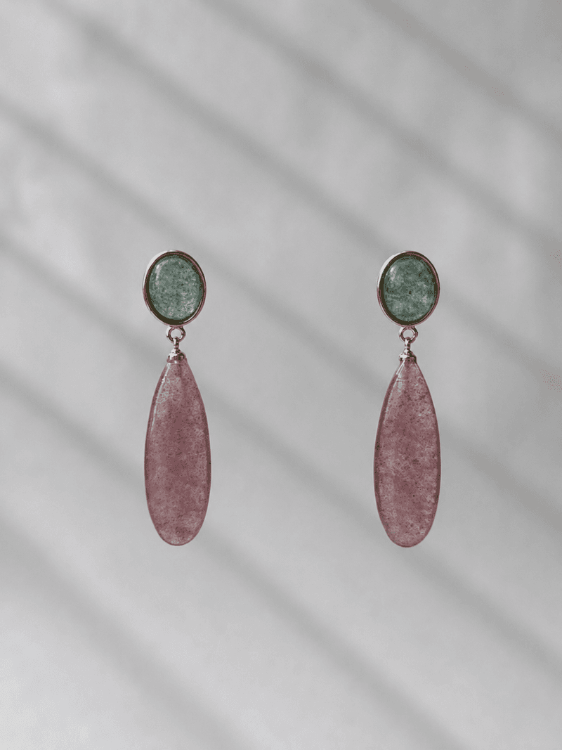 A pair of drop earrings, each a round sparkling green stone in a gold bezel above a long pink teardrop