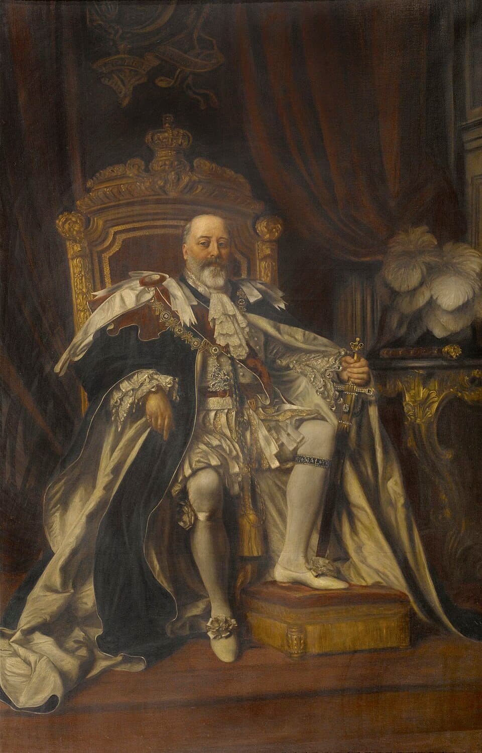 A painted portrait of King Edward VII seated in red and ermine robes of state